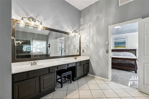 a bathroom with a sink a double vanity and a mirror
