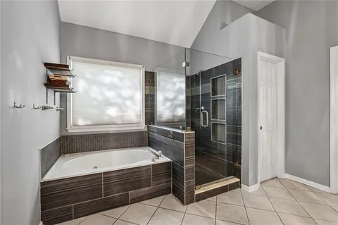 a bathroom with a bathtub and a shower