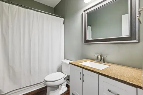 a bathroom with a toilet sink and mirror