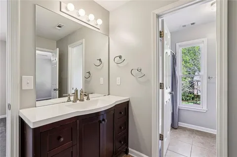 a bathroom with a sink vanity and a mirror