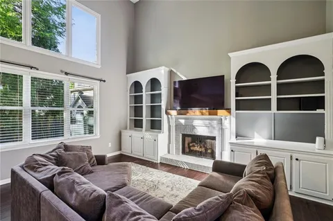 a living room with furniture a fireplace and windows