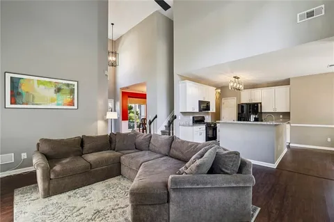 a living room with furniture and a kitchen view