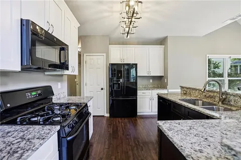 a kitchen with a stove a sink and a refrigerator