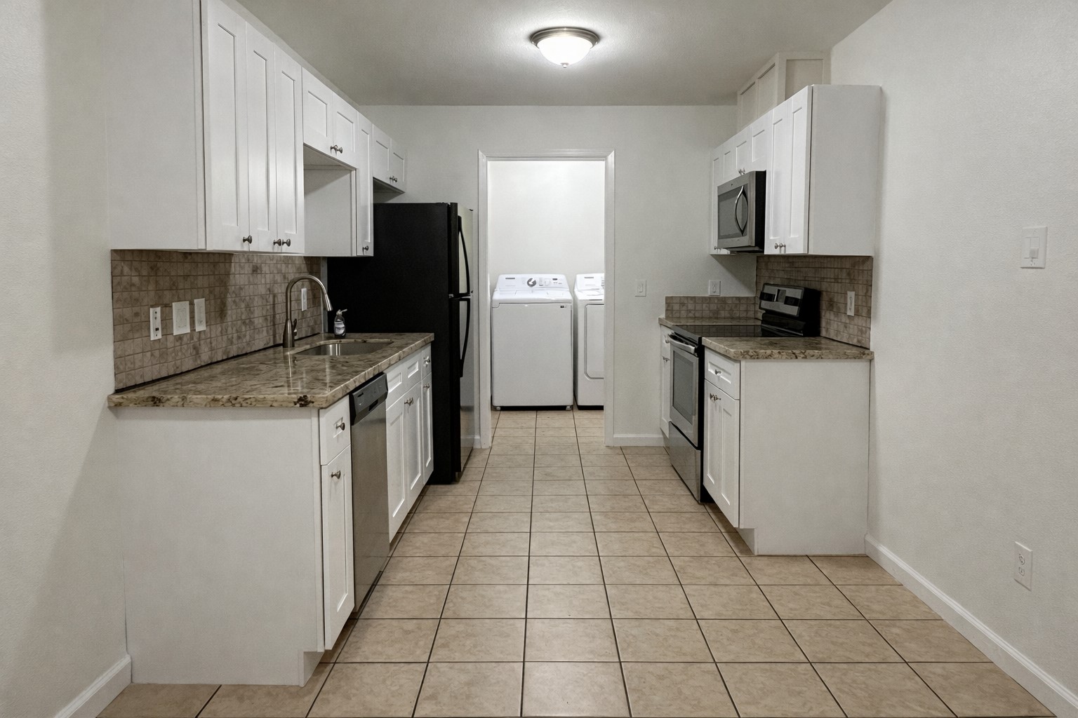 6619 Carver Road, Unit B Houston, TX 77091 - Photo 2 of 12 a kitchen with stainless steel appliances granite countertop a refrigerator and a stove