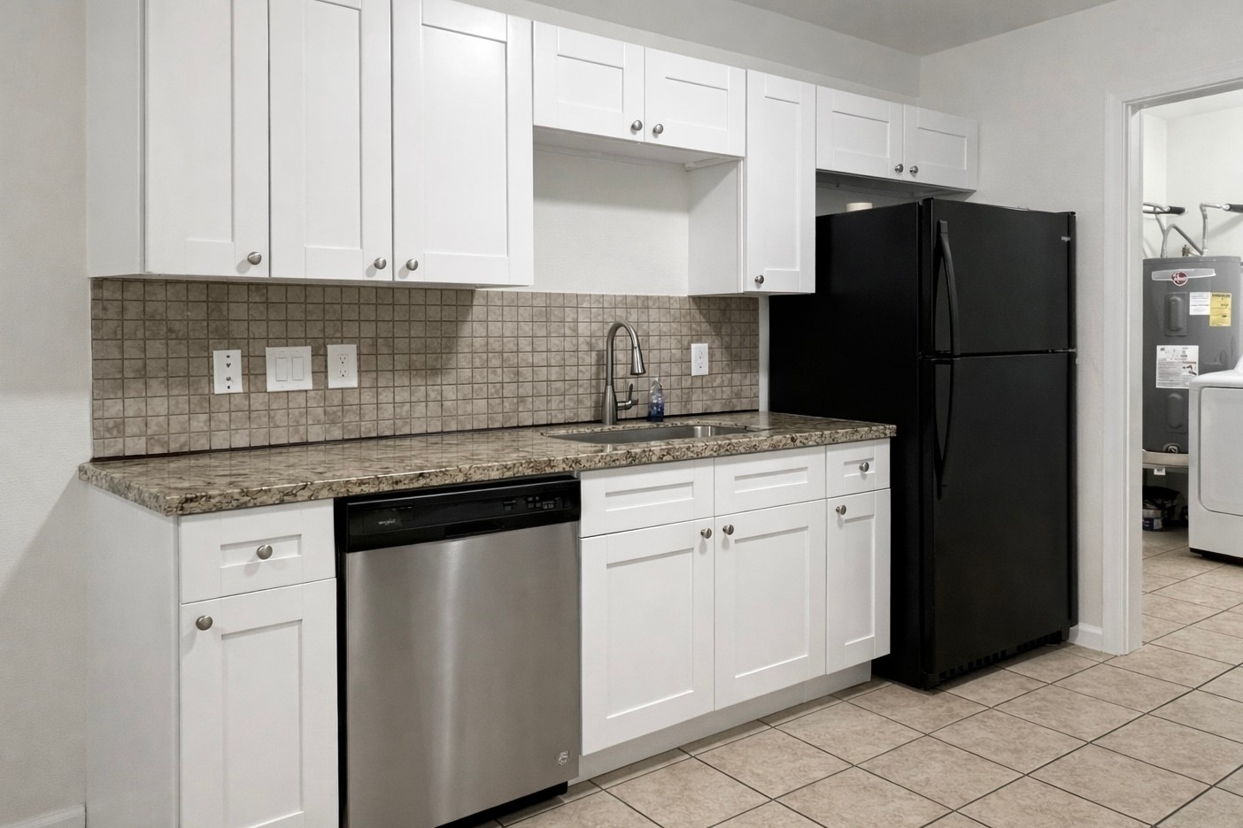 6619 Carver Road, Unit B Houston, TX 77091 - Photo 4 of 12 a kitchen with granite countertop white cabinets and stainless steel appliances