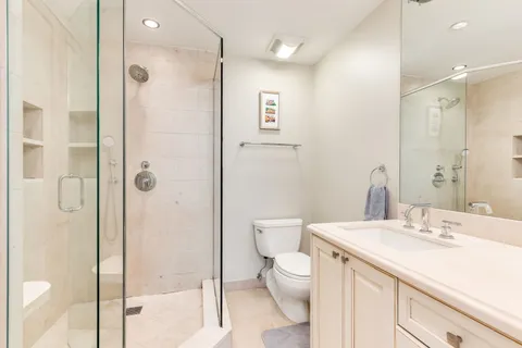 a bathroom with a sink a toilet and shower