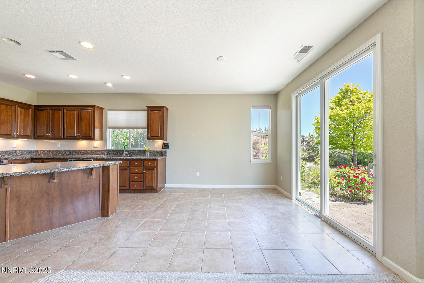 8890 Chipshot Trail Reno, NV 89523 - Photo 13 of 36 a kitchen with stainless steel appliances kitchen island granite countertop a refrigerator and a sink