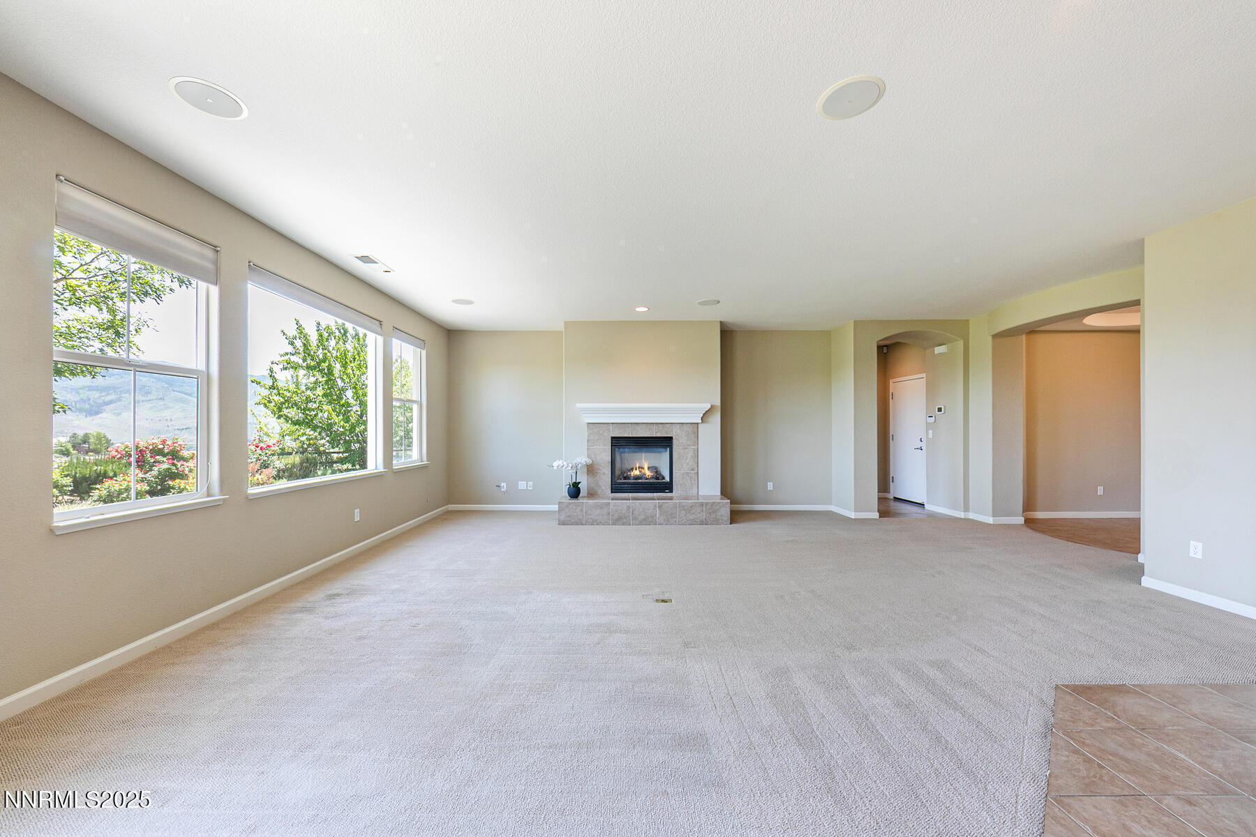 8890 Chipshot Trail Reno, NV 89523 - Photo 14 of 36 a view of empty room with windows and fireplace