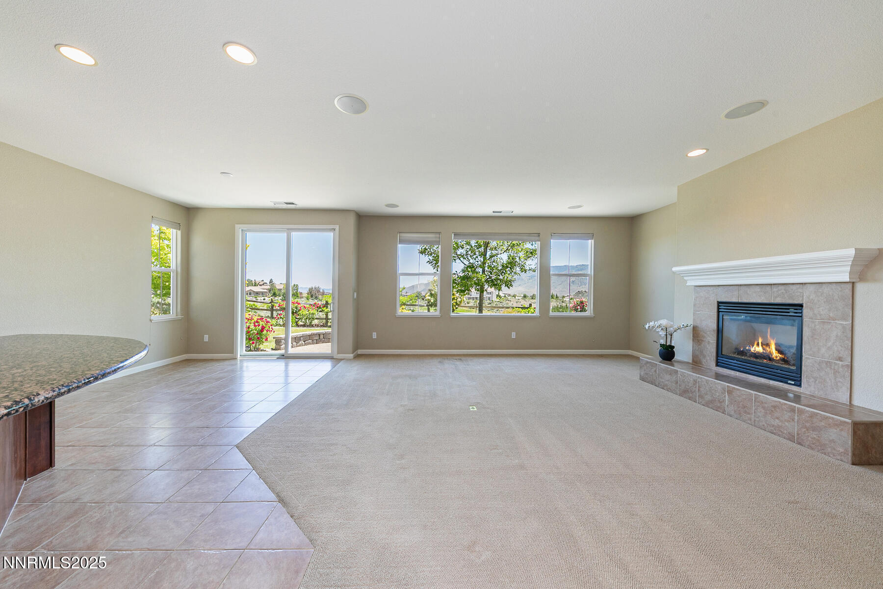 8890 Chipshot Trail Reno, NV 89523 - Photo 17 of 36 an empty room with windows and fireplace