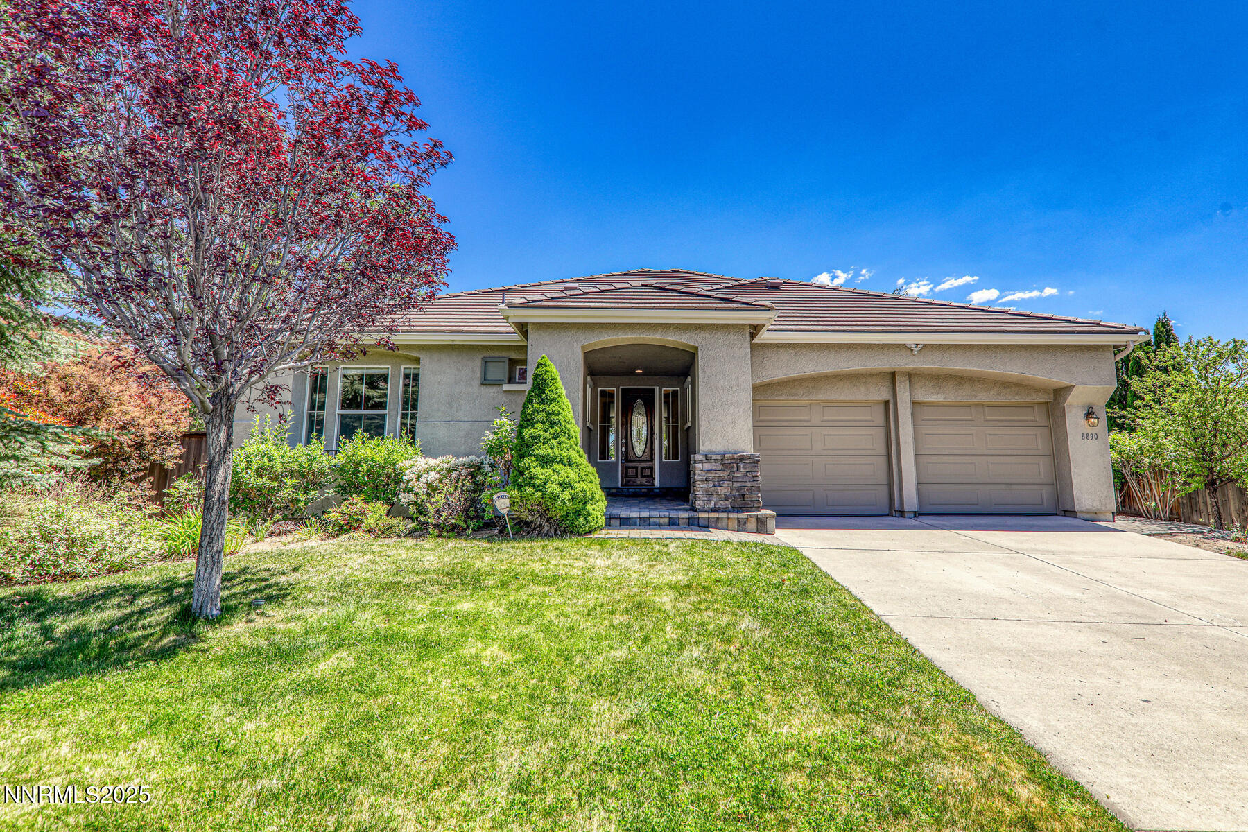 8890 Chipshot Trail Reno, NV 89523 - Photo 2 of 36 a front view of a house with a yard and garage