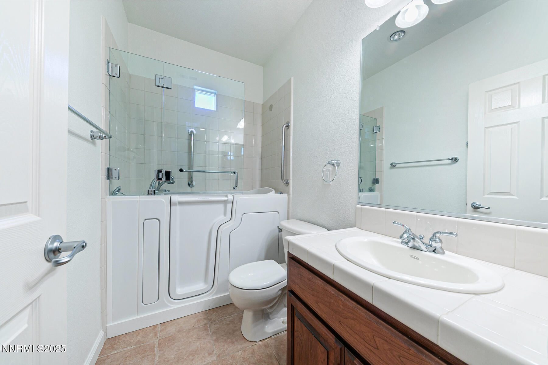 8890 Chipshot Trail Reno, NV 89523 - Photo 26 of 36 a bathroom with a sink a toilet and a mirror