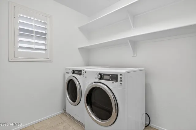 a bathroom with a sink a toilet and a large mirror