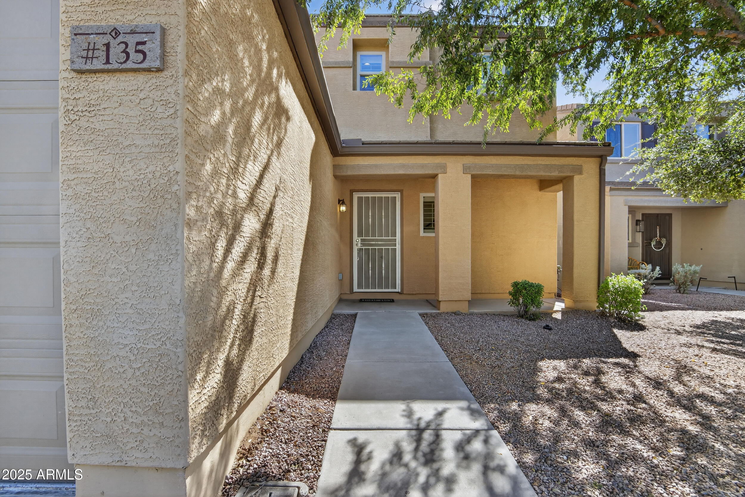 2565 East Southern Avenue, Unit 135 Mesa, AZ 85204 - Photo 2 of 32 a front view of a house with a yard