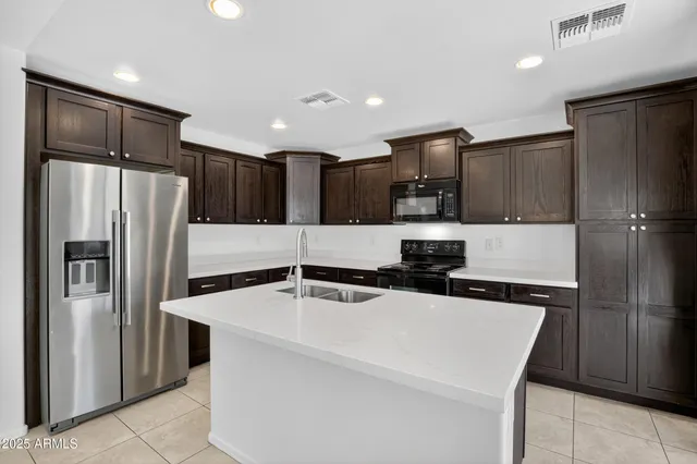 a kitchen with stainless steel appliances a refrigerator and a stove