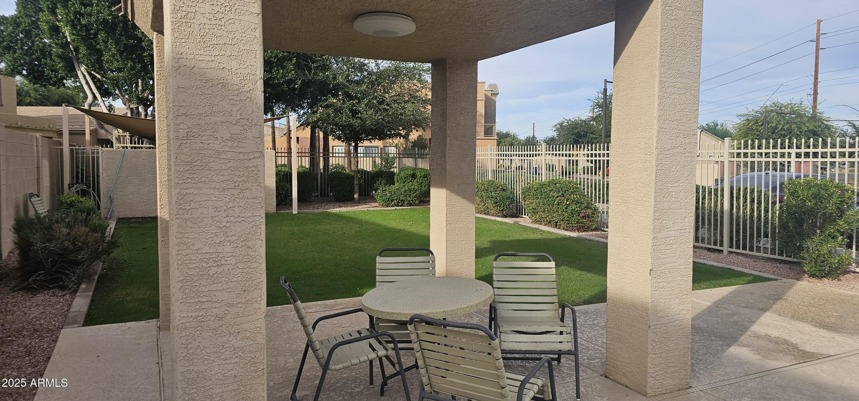 2565 East Southern Avenue, Unit 135 Mesa, AZ 85204 - Photo 32 of 32 a view of a chairs and table in patio with a yard