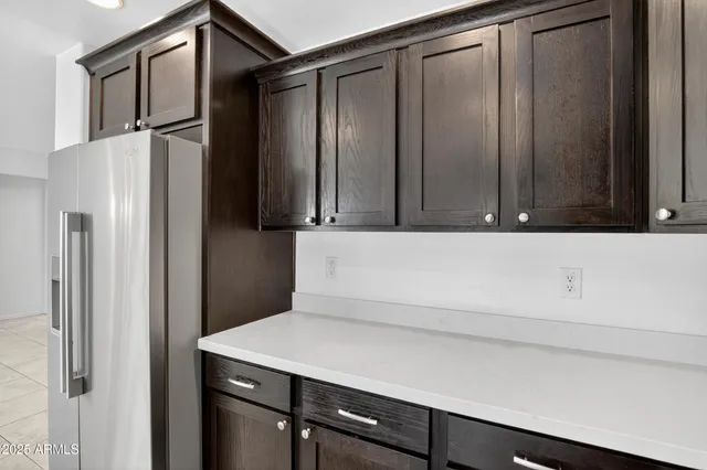 a kitchen with a refrigerator and cabinets