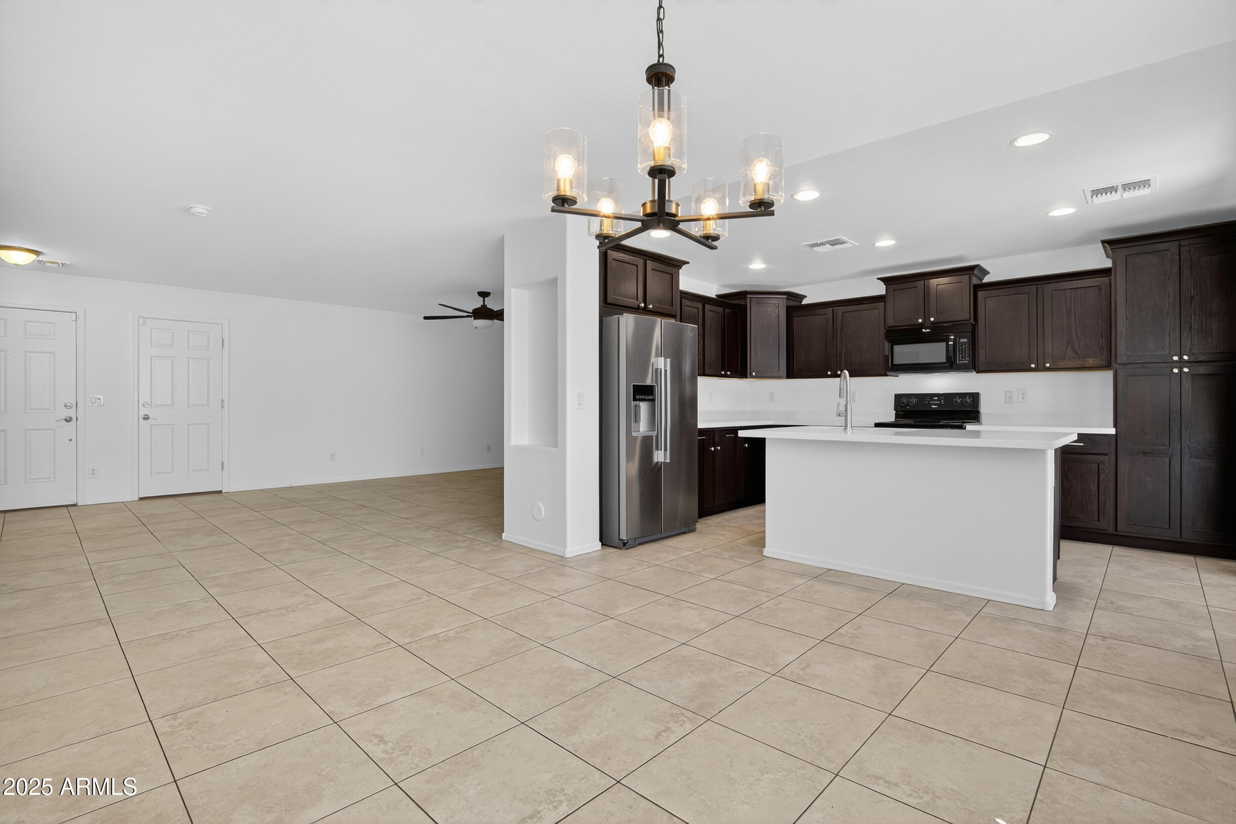 2565 East Southern Avenue, Unit 135 Mesa, AZ 85204 - Photo 6 of 32 a kitchen with stainless steel appliances kitchen island granite countertop a refrigerator and a stove top oven