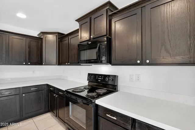 a kitchen with granite countertop a stove and a microwave