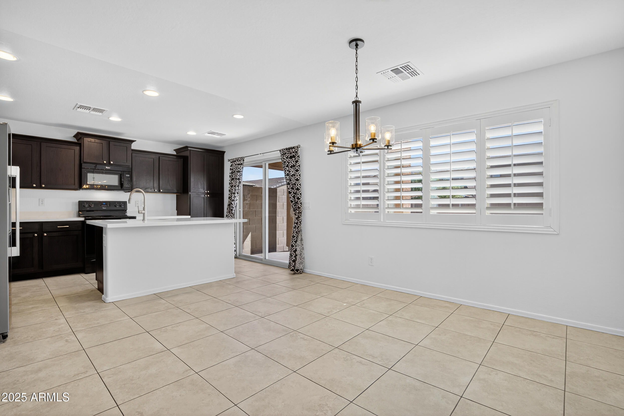 2565 East Southern Avenue, Unit 135 Mesa, AZ 85204 - Photo 9 of 32 a kitchen with stainless steel appliances kitchen island granite countertop a refrigerator a sink and a stove