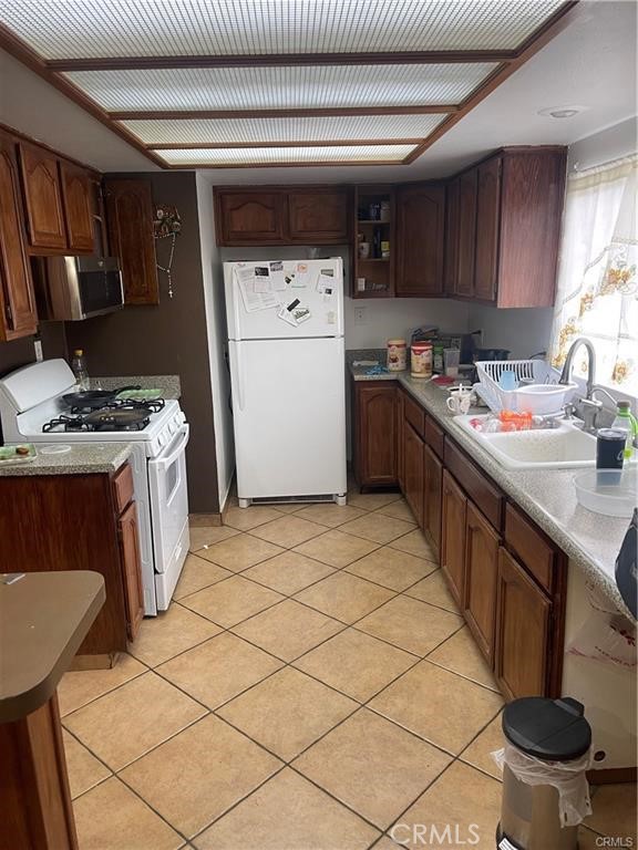 6191 Streeter Avenue Riverside, CA 92504 - Photo 3 of 8 a kitchen with a sink a stove and cabinets