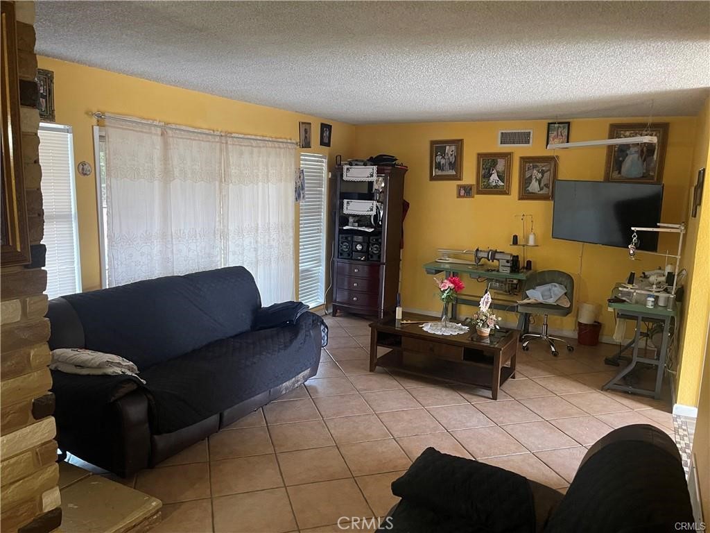 6191 Streeter Avenue Riverside, CA 92504 - Photo 5 of 8 a living room with furniture and a flat screen tv