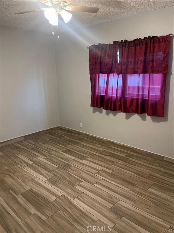 6191 Streeter Avenue Riverside, CA 92504 - Photo 6 of 8 a view of a room with wooden floor