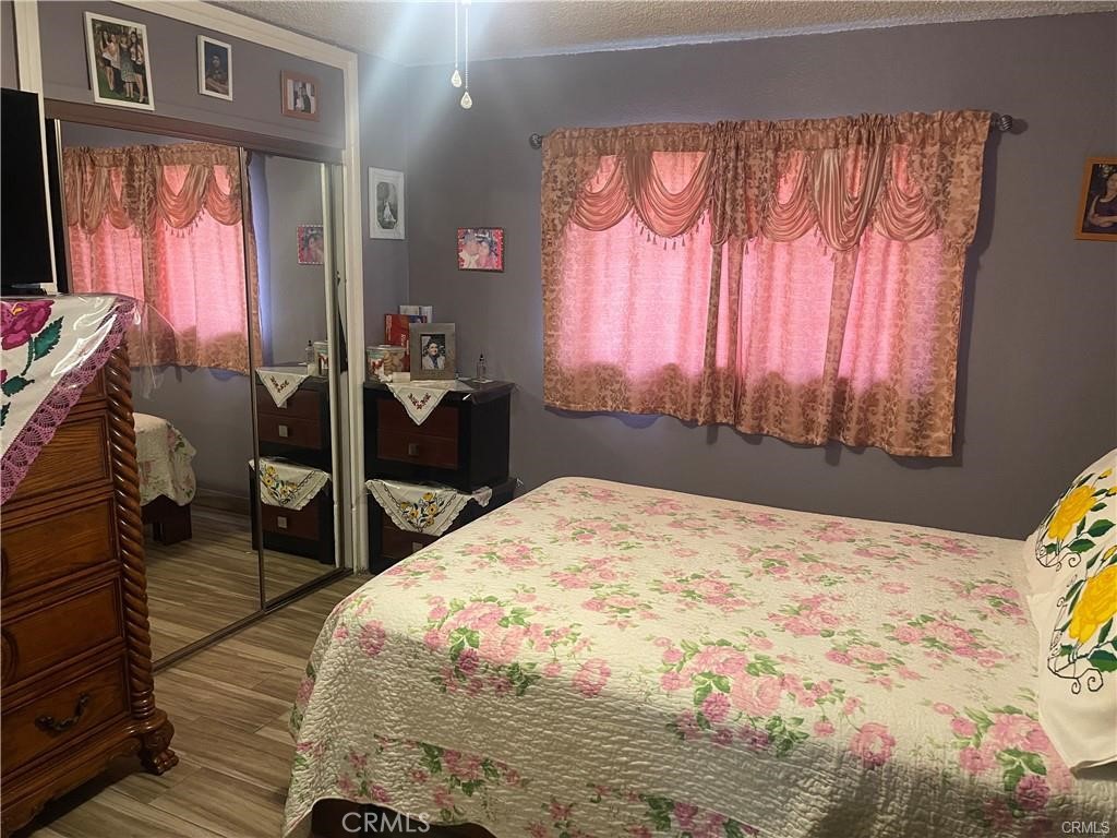 6191 Streeter Avenue Riverside, CA 92504 - Photo 7 of 8 a bed sitting in a bedroom next to a window