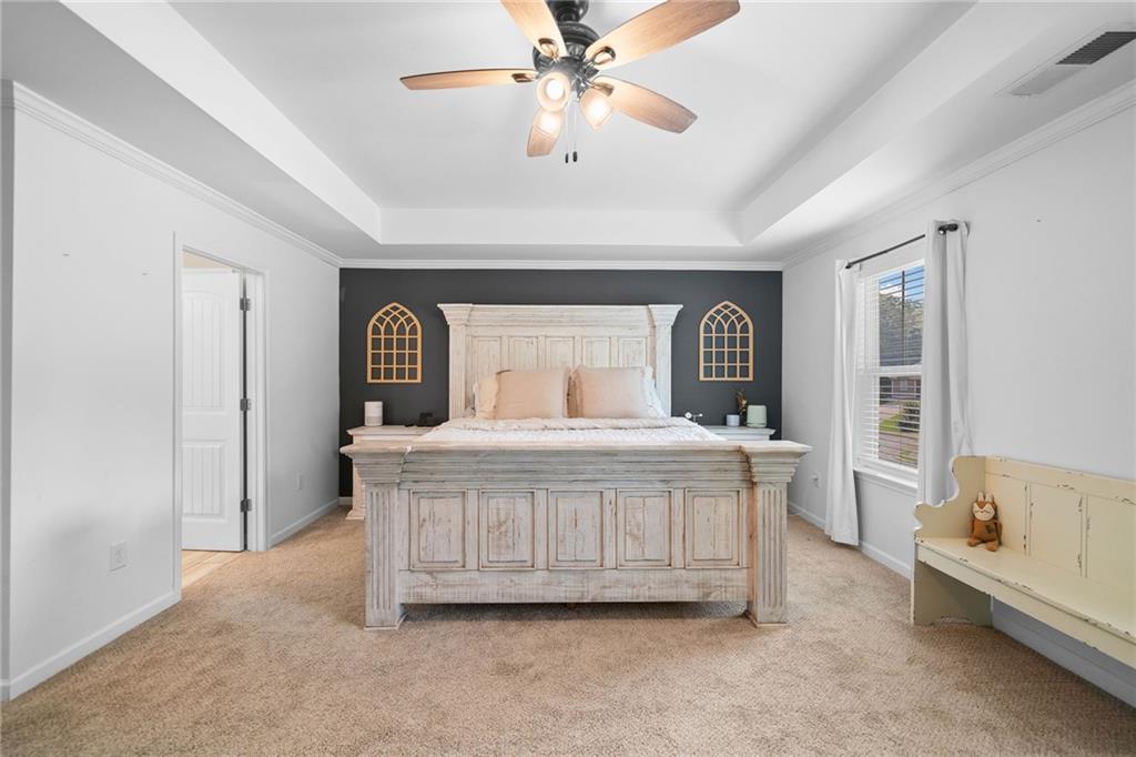 13 Four Feathers Lane Northeast Rydal, GA 30171 - Photo 29 of 51 a large bed sitting in a room next to a window and a chandelier