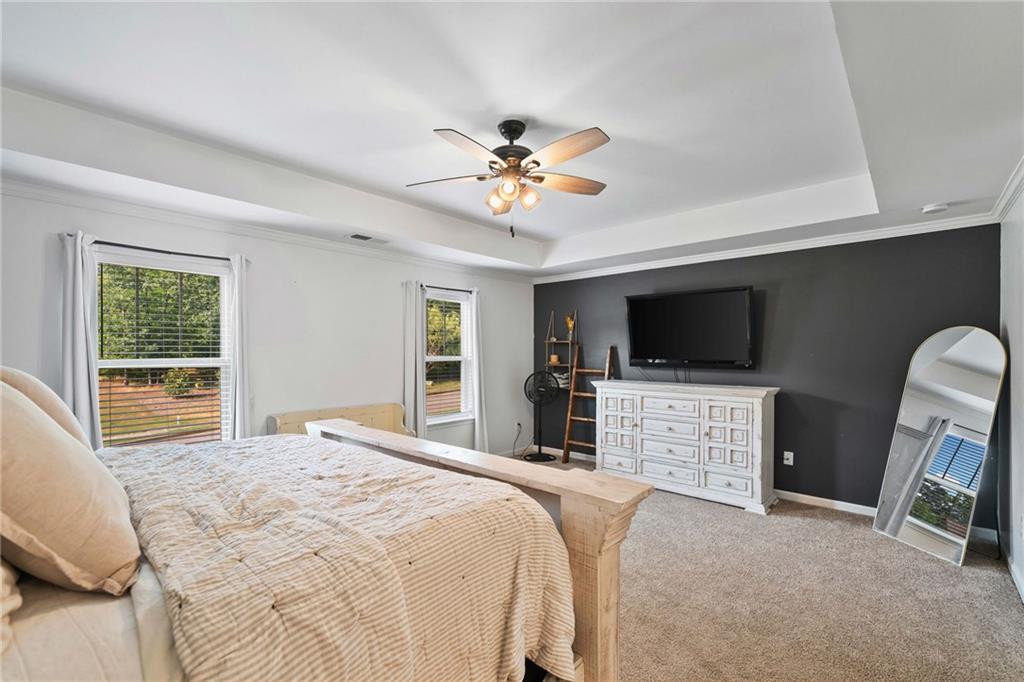 13 Four Feathers Lane Northeast Rydal, GA 30171 - Photo 31 of 51 a bedroom with a bed flat screen tv and a couch
