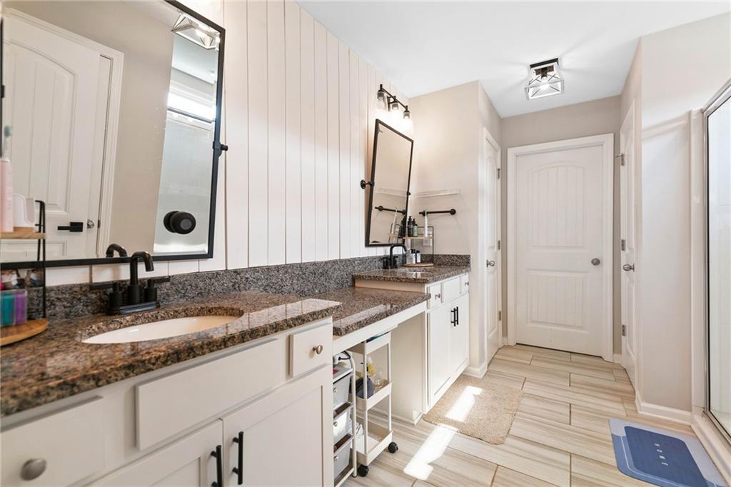 13 Four Feathers Lane Northeast Rydal, GA 30171 - Photo 32 of 51 a bathroom with a granite countertop double vanity sink and mirror