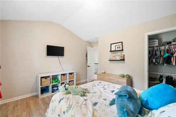 a bed room with a bed and a television