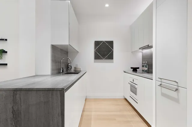 a kitchen with stainless steel appliances granite countertop a sink and a stove