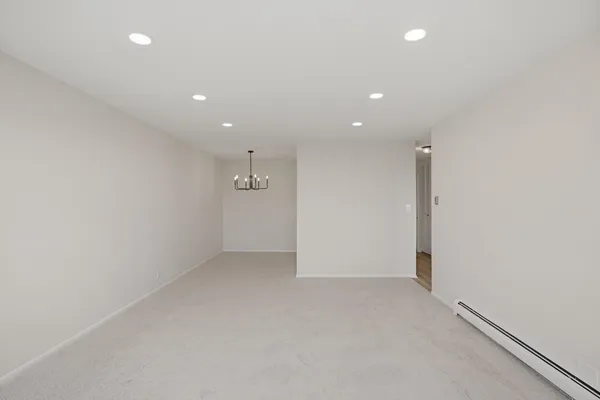 an empty room with a empty space and windows