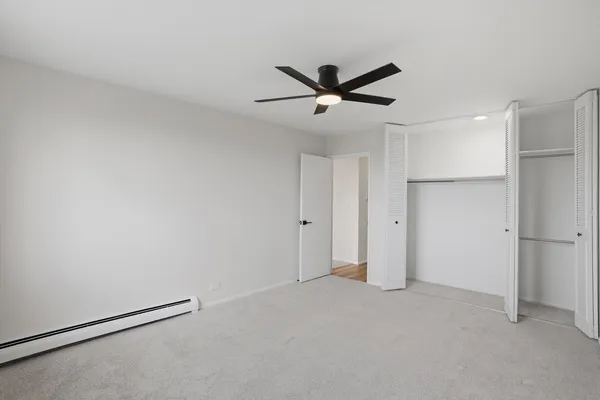 a view of a room with window and ceiling fan