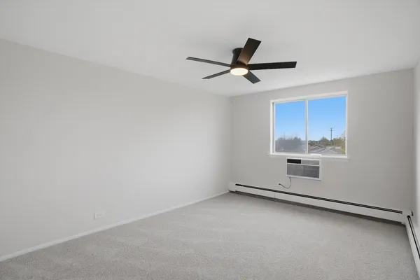 a view of a livingroom with furniture and a ceiling fan