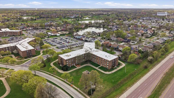 an aerial view of a residential apartment building with a outdoor space