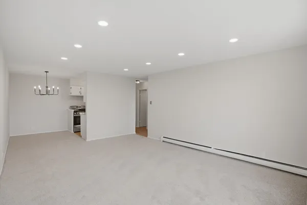 an empty room with a empty space and windows