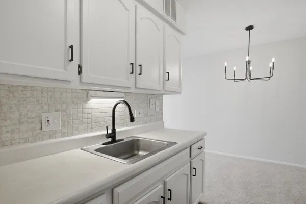 a kitchen with a sink and cabinets