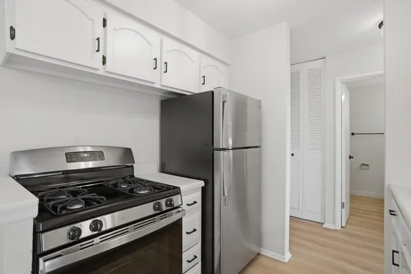 a kitchen with a stove and a refrigerator
