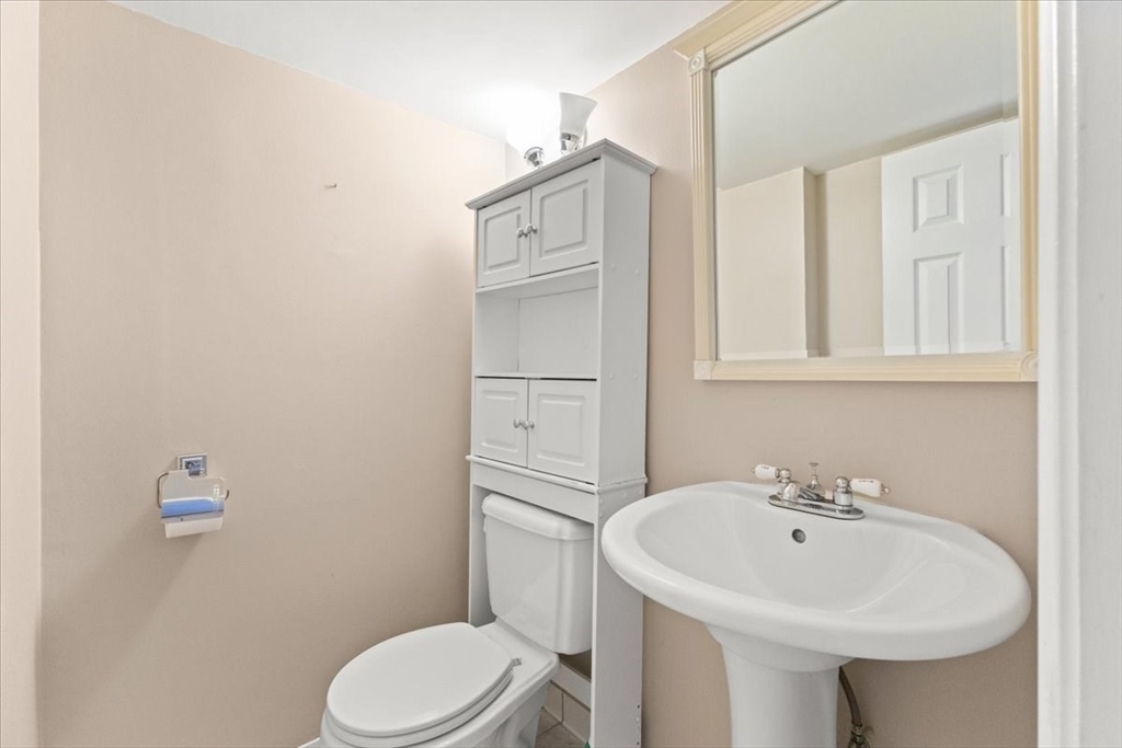 212 Washington Street, Unit 212 Canton, MA 02021 - Photo 13 of 35 a bathroom with a sink a toilet and mirror