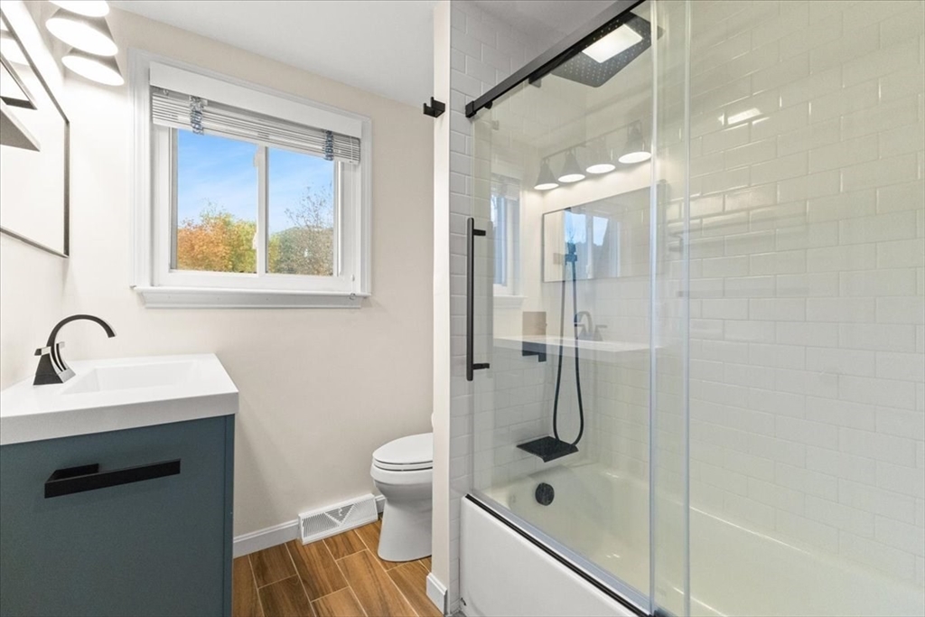 212 Washington Street, Unit 212 Canton, MA 02021 - Photo 14 of 35 a bathroom with a granite countertop sink toilet and shower