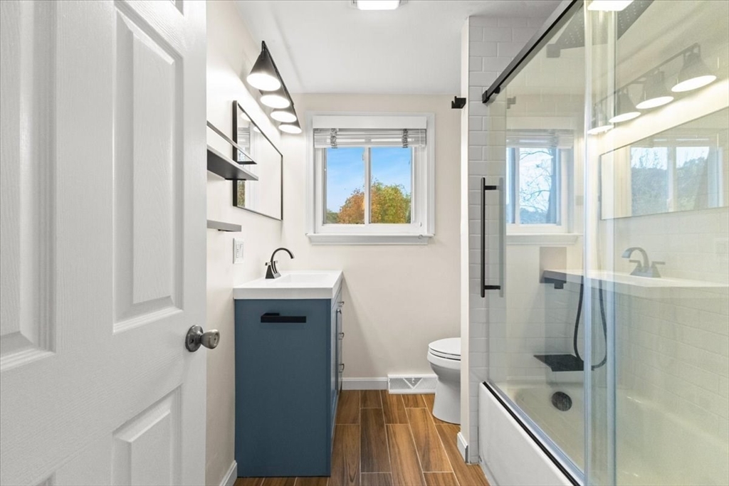 212 Washington Street, Unit 212 Canton, MA 02021 - Photo 15 of 35 a bathroom with a sink a toilet and shower