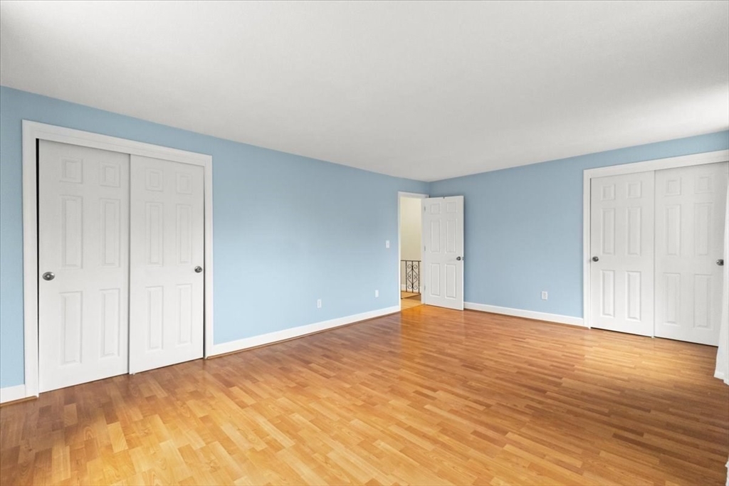 212 Washington Street, Unit 212 Canton, MA 02021 - Photo 18 of 35 a view of an empty room and wooden floor