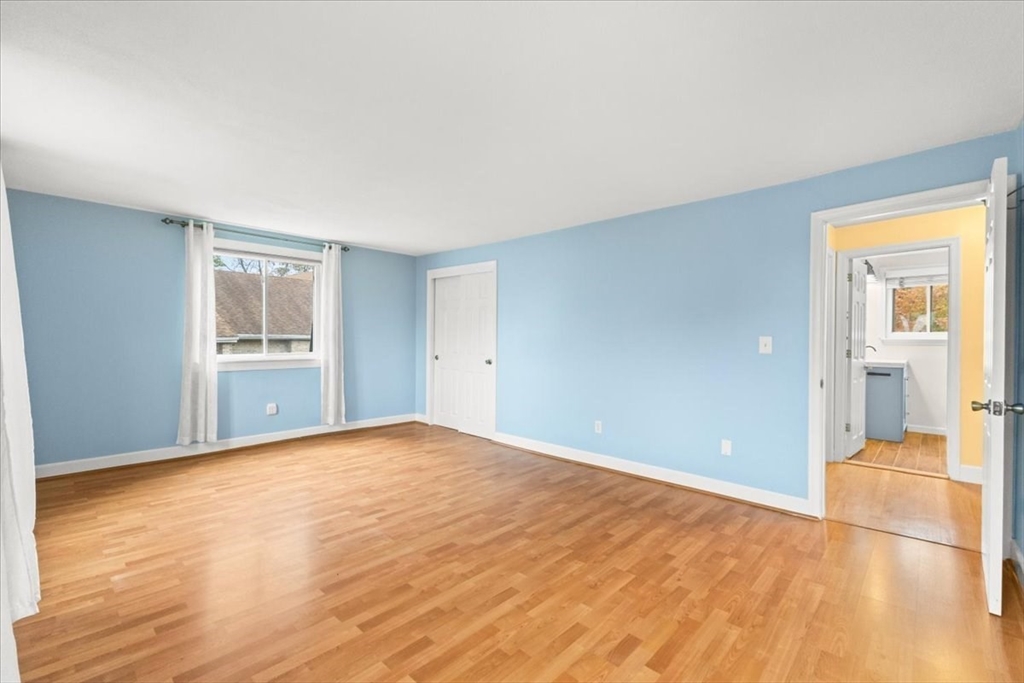 212 Washington Street, Unit 212 Canton, MA 02021 - Photo 19 of 35 a view of an empty room with wooden floor and a window