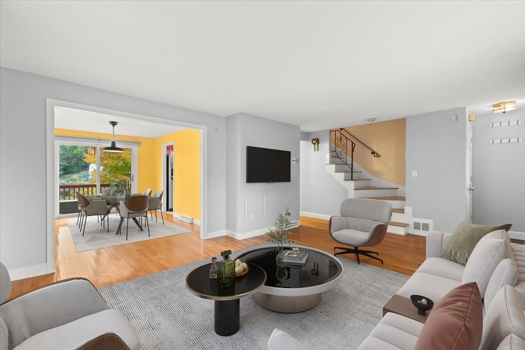 212 Washington Street, Unit 212 Canton, MA 02021 - Photo 2 of 35 a living room with furniture and a flat screen tv