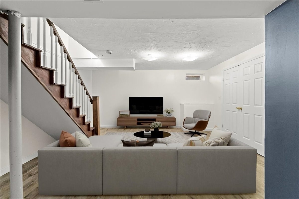 212 Washington Street, Unit 212 Canton, MA 02021 - Photo 23 of 35 a living room with furniture and a flat screen tv