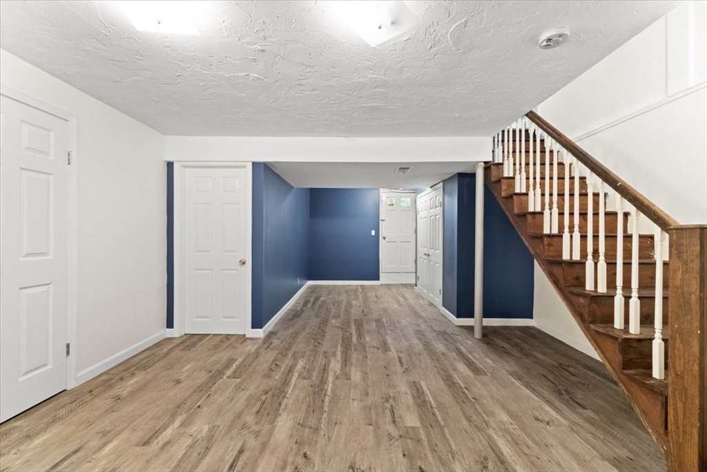 212 Washington Street, Unit 212 Canton, MA 02021 - Photo 24 of 35 a view of hallway with wooden floor and stairs