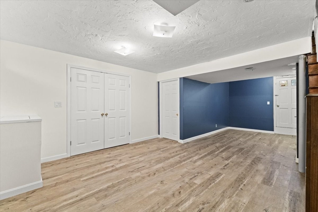 212 Washington Street, Unit 212 Canton, MA 02021 - Photo 25 of 35 a view of empty room with wooden floor