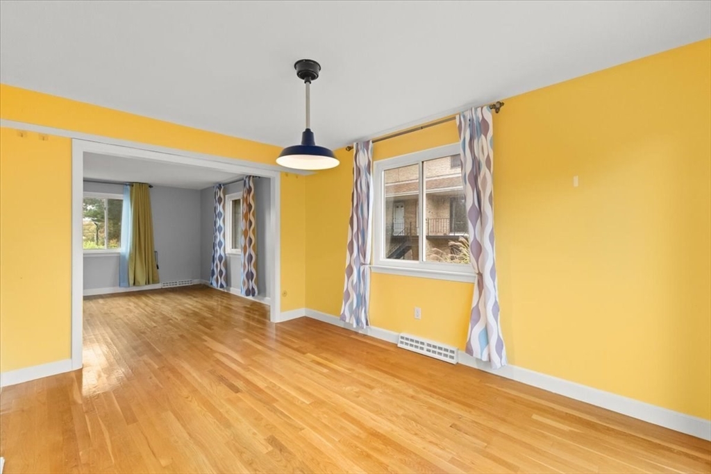 212 Washington Street, Unit 212 Canton, MA 02021 - Photo 6 of 35 a view of empty room with wooden floor and fan