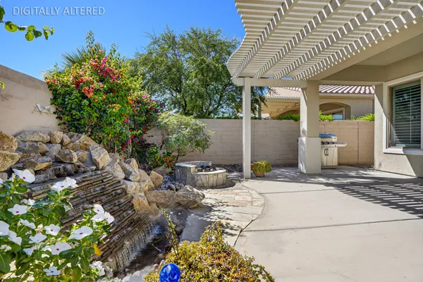 a view of a patio with table and chairs potted plants with wooden floor and fence